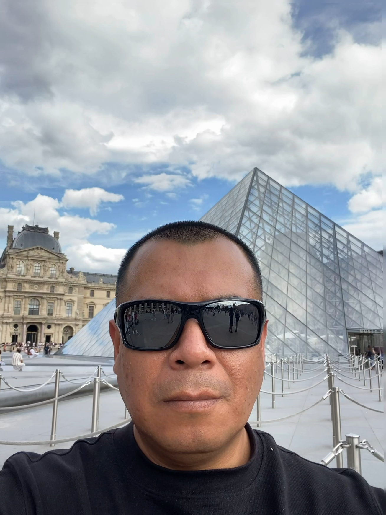 Aldo frente a la Pirámide del Louvre en París